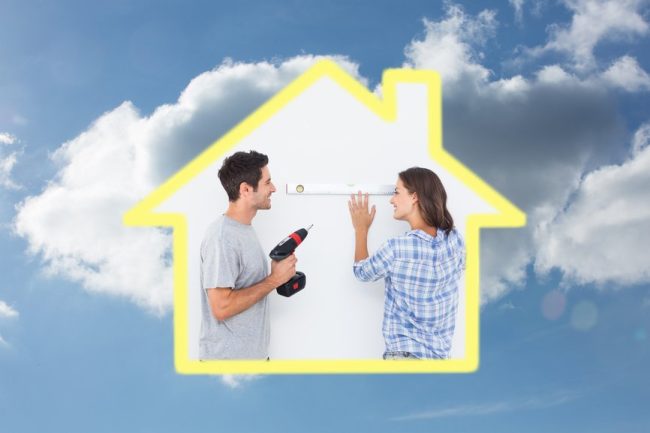 Cheerful man and his wife doing home improvements together against cloudy sky